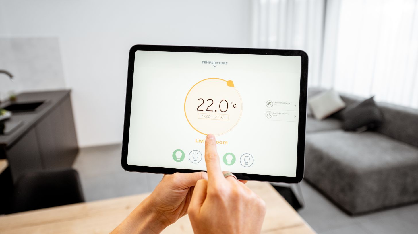 a person operating thermostat settings on tablet