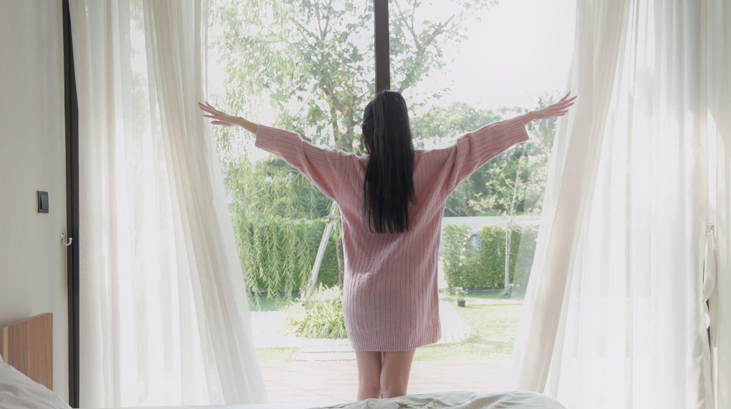a woman happily opening her windows