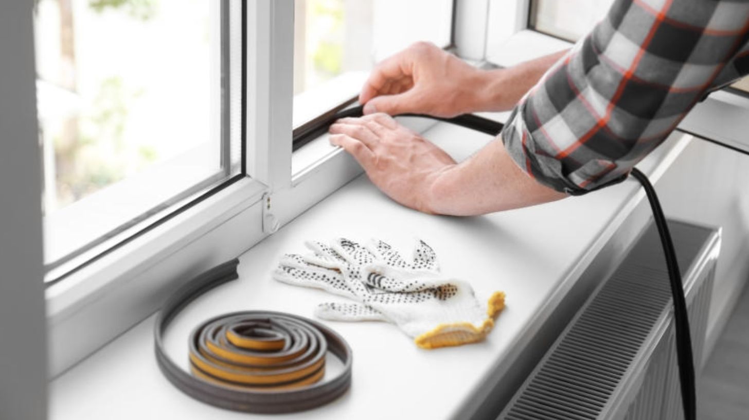 weather stripping being installed on a window