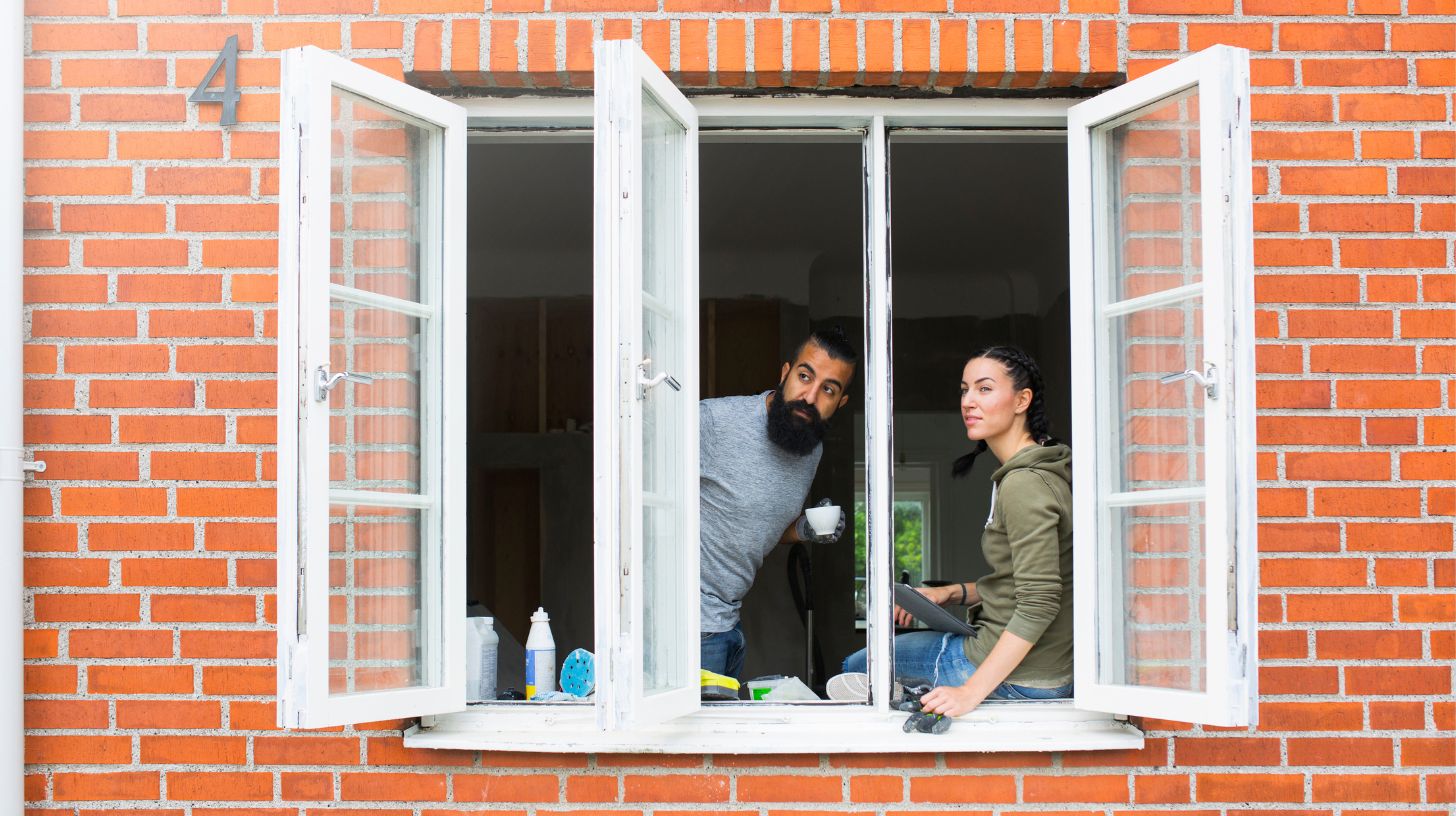 Two people looking out their double-glazed windows
