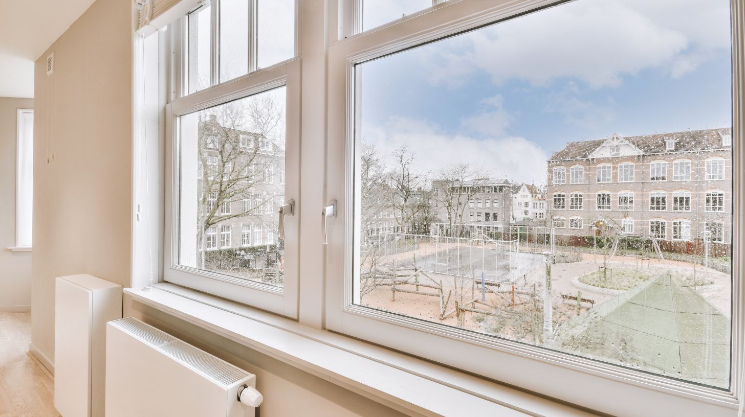 a large window with a view of a school
